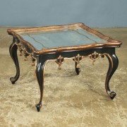 antique glass-topped cocktail table with black lacquer, gold gilding
